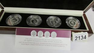 A cased set of four 60th anniversary of the coronation of Queen Elizabeth II silver coins featuring