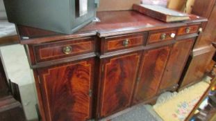 A mahogany string inlaid break front sideboard in clean condition.