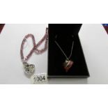 A Fiorelli heart pendant in silver and a heart pendant in shades of pink,
