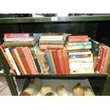 A shelf full of books on many subjects (annuals,
