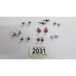 8 pairs of assorted silver earrings.