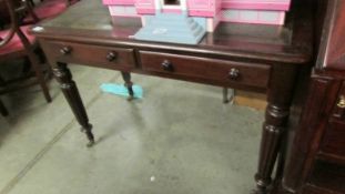 A 2 drawer mahogany writing table by Edwards and Roberts