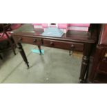 A 2 drawer mahogany writing table by Edwards and Roberts