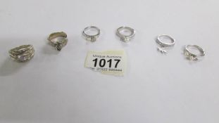 6 assorted silver rings.