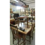 A 1930's oak draw leaf table and 4 chairs.