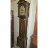 A mahogany cased 8 day brass dial Grandfather clock with inlaid door and base.