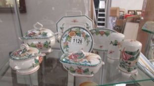 A quantity of hand painted Portuguese china including miniature tureens, salt and pepper etc.