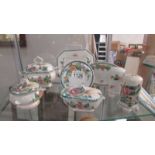 A quantity of hand painted Portuguese china including miniature tureens, salt and pepper etc.