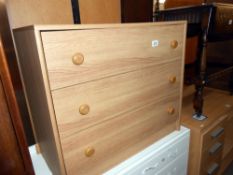 A light oak effect bedroom chest of drawers, height 65.5cm, width 76cm approx.