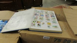 3 boxes of assorted stamps, loose and in albums.