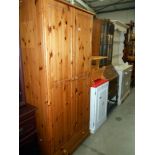 A solid pine 2 door wardrobe (has electric socket for a plug attached and hole in back for a plug