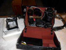 A Nikon and Vivitar lens in carry case,