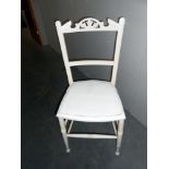 A vintage white painted kitchen chair