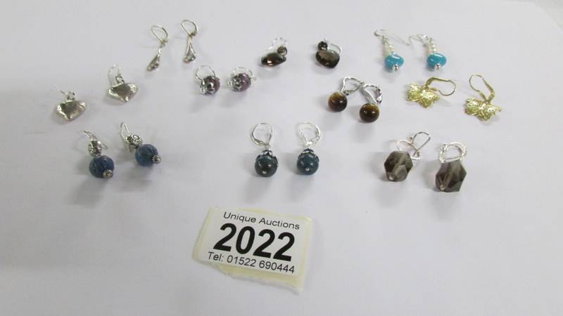 Ten pairs of assorted silver earrings.