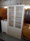 A limed oak effect 2 door 2 cupboard display cabinet bookcase, height 182cm, width 90cm approx.