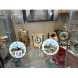 Two small mantel clocks depicting windmills, a battery lantern clock and a battery carriage clock.