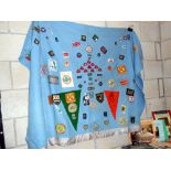 An old scouts blanket with large quantity of scouting badges sewn on