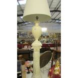 A cream pottery table lamp with shade on a plaster pillar, lamp needs rewiring, (pillar 64.
