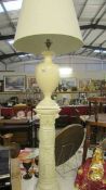 A cream pottery table lamp with shade on a plaster pillar, lamp needs rewiring, (pillar 64.
