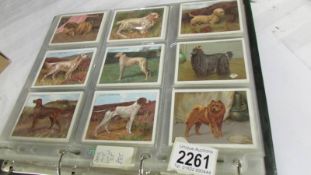 An album of cigarette cards including Players Dogs, Treasures of Britain, Famous Beauties,