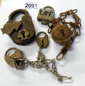 Three vintage padlocks, one with attached chain and a watch chain.