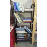 Four shelved of nautical related books (History, sailing handbooks, skills etc.,).