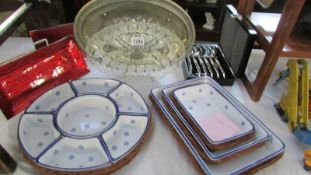 A quantity of miscellaneous kitchenware including wicker covered serving dishes etc.