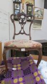 A 1920's mahogany hall chair with carved back.