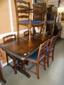 A dark oak refectory style dining table and 6 ladderback chairs, height 78cm,