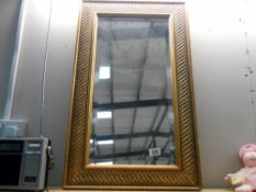 A gilded bevel edge mirror 76cm x 45cm