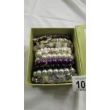 Ten assorted bracelets.