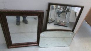 A framed bevel edged mirror and 2 other mirrors.