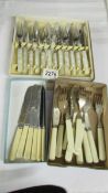 A boxed set of fish knives and forks and other cutlery.