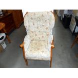 A wood framed upholstered armchair
