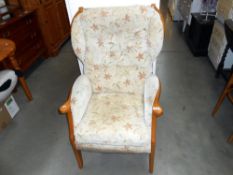 A wood framed upholstered armchair