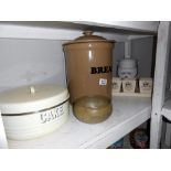 A large lidded stoneware bread bin, Ringtons porcelain lidded pot, cake tin (bottom a/f) etc.