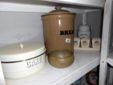 A large lidded stoneware bread bin, Ringtons porcelain lidded pot, cake tin (bottom a/f) etc.