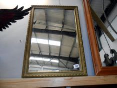 A wooden framed mirror, slight a/f to frame size 67.