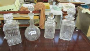 Four cut glass decanters.