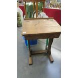 A vintage oak school desk with lift up top and inkwell aperture.