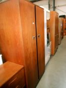 A Gents 2 door teak wardrobe with half hanging on one side and 4 shelves, tie rack,