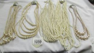 Five multi strand 'pearl' necklaces,