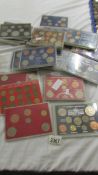 In excess of 30 cased sets of English coins.