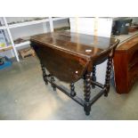 A Victorian oak gateleg table on barley twist legs, height 72cm,