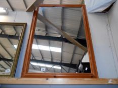 A large wooden framed mirror size 101cm x 72.