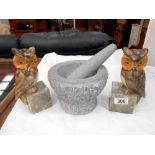 A pair of polished stone owl bookends (ears a/f) and a heavy stone pestle and mortar