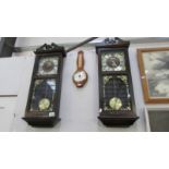 A pair of modern President wall clocks and a barometer.