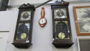 A pair of modern President wall clocks and a barometer.