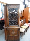 A dark oak lead glass glazed corner cabinet,