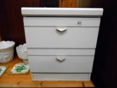 A white bedside chest of drawers with glass top, height 52cm, width 45cm approx.